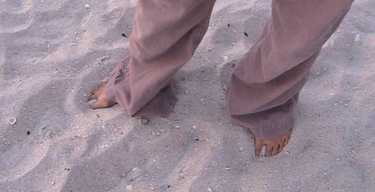 Feet in the sandy beach in Naples Florida